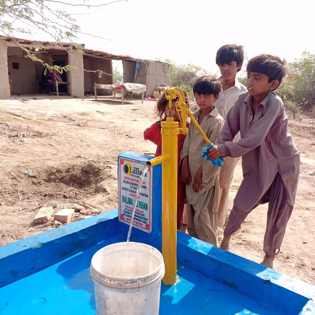 Children at a Lillah Services water pump